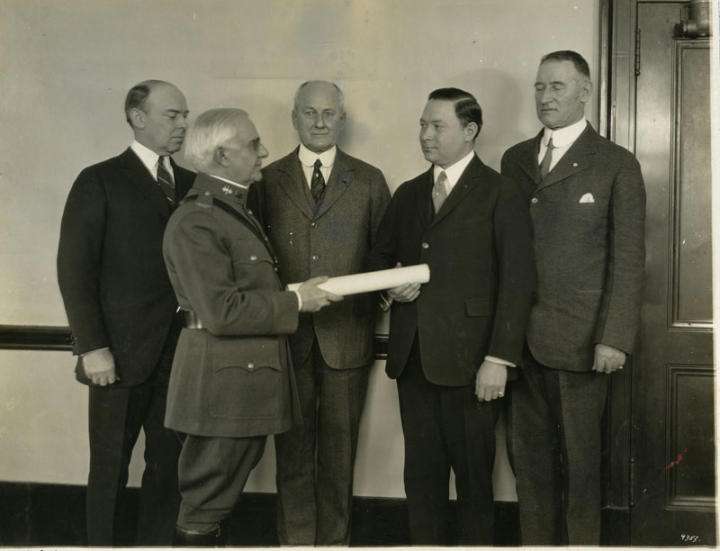 Sarnoff is handed a paper which is his commission into the Army