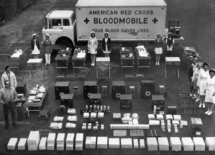 Red Cross bloodmobile set up with all of its supplies and employees.